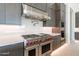 Modern kitchen boasts stainless steel appliances, custom cabinets, and light countertops at 35065 N 83Rd Pl # 4, Scottsdale, AZ 85266
