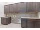 Well-organized laundry room with ample cabinetry, counter space, and modern fixtures at 35065 N 83Rd Pl # 4, Scottsdale, AZ 85266