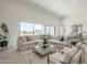 Bright living room with large windows, comfortable seating, and neutral tones creating a welcoming atmosphere at 35065 N 83Rd Pl # 4, Scottsdale, AZ 85266