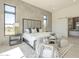 Inviting main bedroom with tiled accent wall, comfortable seating, and large windows offering plenty of natural light at 35065 N 83Rd Pl # 4, Scottsdale, AZ 85266