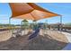 Modern playground with shade structure and wood-chip surface at 44714 N 44Th Dr, Phoenix, AZ 85087