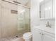 Bright bathroom featuring a walk-in shower with pebble flooring and a modern vanity at 5528 W Sunnyslope Ln, Glendale, AZ 85302
