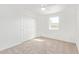 Cozy bedroom with neutral carpet, white walls, closet, and a ceiling fan at 5528 W Sunnyslope Ln, Glendale, AZ 85302