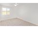 Bright bedroom with carpeted floor, white walls, ceiling fan, and a window at 5528 W Sunnyslope Ln, Glendale, AZ 85302