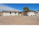 This home features a spacious driveway, desert landscaping, and a covered parking area at 5528 W Sunnyslope Ln, Glendale, AZ 85302