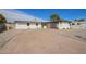 This home features a spacious driveway, desert landscaping, and a covered parking area at 5528 W Sunnyslope Ln, Glendale, AZ 85302