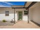 A charming green front door with desert landscaping and a covered entrance at 5528 W Sunnyslope Ln, Glendale, AZ 85302
