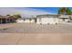 Charming white brick home featuring desert landscaping and a contemporary design at 5528 W Sunnyslope Ln, Glendale, AZ 85302