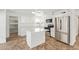 Kitchen featuring quartz countertops, stainless steel appliances, and a functional center island at 5528 W Sunnyslope Ln, Glendale, AZ 85302
