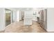 Bright kitchen area with tile floors, an island, stainless appliances and white cabinets at 5528 W Sunnyslope Ln, Glendale, AZ 85302