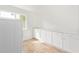 Bright laundry room with tiled floors, white walls, a window, and white storage cabinets at 5528 W Sunnyslope Ln, Glendale, AZ 85302