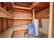 An unfinished storage room with wooden walls and cement bags stacked on wooden shelving at 5528 W Sunnyslope Ln, Glendale, AZ 85302