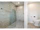 Contemporary bathroom with walk-in shower, tiled walls, and modern fixtures at 7743 E Mariposa Dr, Scottsdale, AZ 85251