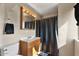 Cozy bathroom featuring a toilet, sink, mirror and shower with a curtain at 8328 W Fairmount Ave, Phoenix, AZ 85037