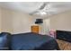 Bedroom with a TV, dresser, and neutral-toned walls with a ceiling fan at 8328 W Fairmount Ave, Phoenix, AZ 85037