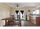 Dining area features a dark wood table, wood-look floors, and doors leading to the backyard at 8328 W Fairmount Ave, Phoenix, AZ 85037