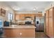 Kitchen featuring wood cabinets, stainless steel appliances, and ample counter space at 8328 W Fairmount Ave, Phoenix, AZ 85037