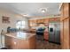 Bright kitchen with stainless steel appliances, wood cabinets and laminate countertops at 8328 W Fairmount Ave, Phoenix, AZ 85037