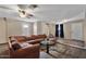 A large, comfortable sectional sits in the living room, with wood-look floors and access to other areas at 8328 W Fairmount Ave, Phoenix, AZ 85037