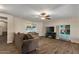 Open-concept living space with neutral walls, wood-look floors, and a modern entertainment center at 8328 W Fairmount Ave, Phoenix, AZ 85037