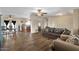Comfortable living space featuring wood-look floors, with a dining area visible in the background at 8328 W Fairmount Ave, Phoenix, AZ 85037