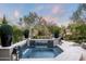 Serene backyard with a spa, fountain, and lush landscaping at 9290 E Thompson Peak Pkwy # 422, Scottsdale, AZ 85255