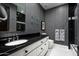 Bathroom with black and white tile and floating shelves at 9290 E Thompson Peak Pkwy # 422, Scottsdale, AZ 85255