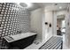 Luxurious bathroom with freestanding tub, geometric tile, and walk-in shower at 9290 E Thompson Peak Pkwy # 422, Scottsdale, AZ 85255