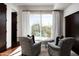 Relaxing bedroom with two armchairs and access to a private patio at 9290 E Thompson Peak Pkwy # 422, Scottsdale, AZ 85255