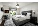 Spacious bedroom with gray upholstered bed and large window at 9290 E Thompson Peak Pkwy # 422, Scottsdale, AZ 85255