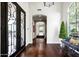 Elegant entry with dark wood floors, iron doors, and a charming bench at 9290 E Thompson Peak Pkwy # 422, Scottsdale, AZ 85255