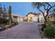 Elegant home exterior featuring a grand entrance and desert landscaping at 9290 E Thompson Peak Pkwy # 422, Scottsdale, AZ 85255