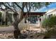 House exterior with stucco siding, wooden pergola, and desert landscaping at 9290 E Thompson Peak Pkwy # 422, Scottsdale, AZ 85255