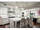 Gourmet kitchen with white cabinets, marble island, and pendant lighting at 9290 E Thompson Peak Pkwy # 422, Scottsdale, AZ 85255