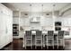Modern kitchen with white cabinets, marble countertops, and island seating at 9290 E Thompson Peak Pkwy # 422, Scottsdale, AZ 85255