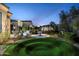 Landscaped backyard with circular lawn feature and mature trees at 9290 E Thompson Peak Pkwy # 422, Scottsdale, AZ 85255