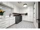 Bright laundry room with white cabinets and patterned tile floor at 9290 E Thompson Peak Pkwy # 422, Scottsdale, AZ 85255