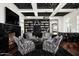 Elegant library with built-in bookshelves, fireplace, and comfortable seating at 9290 E Thompson Peak Pkwy # 422, Scottsdale, AZ 85255