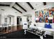 Spacious living area with hardwood floors, high ceilings, and a large art piece at 9290 E Thompson Peak Pkwy # 422, Scottsdale, AZ 85255