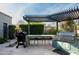 Outdoor kitchen with built-in grill, pergola, and seating area at 9290 E Thompson Peak Pkwy # 422, Scottsdale, AZ 85255