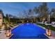 Expansive lighted pool with surrounding landscaping and patio furniture at 9290 E Thompson Peak Pkwy # 422, Scottsdale, AZ 85255