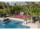 Landscaped garden with vibrant flowers surrounding a tranquil pool at 9290 E Thompson Peak Pkwy # 422, Scottsdale, AZ 85255