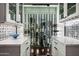 Modern wine cellar with glass walls showcasing an extensive collection at 9290 E Thompson Peak Pkwy # 422, Scottsdale, AZ 85255