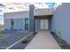 Modern home exterior with gray and white color scheme, landscaped walkway, and cacti at 10226 N 171St Dr, Waddell, AZ 85355