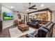 Spacious living room featuring a large TV, leather furniture, and hardwood floors at 103 W Tanya Rd, Phoenix, AZ 85086