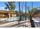 Community pool surrounded by palm trees offers a refreshing oasis for residents at 10426 N 11Th St # 3, Phoenix, AZ 85020