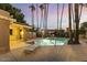 Community pool with lounge chairs under a sunset sky, enhanced by desert landscaping and palm trees at 10426 N 11Th St # 3, Phoenix, AZ 85020