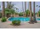 Outdoor community pool surrounded by desert landscaping and tall palm trees at 10426 N 11Th St # 3, Phoenix, AZ 85020