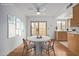 Cozy dining area features a round table, modern ceiling fan, and bright natural light from the sliding door at 10426 N 11Th St # 3, Phoenix, AZ 85020