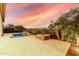 Landscaped backyard oasis featuring a pool and fire pit at 1175 E Copper Holw, Queen Creek, AZ 85140